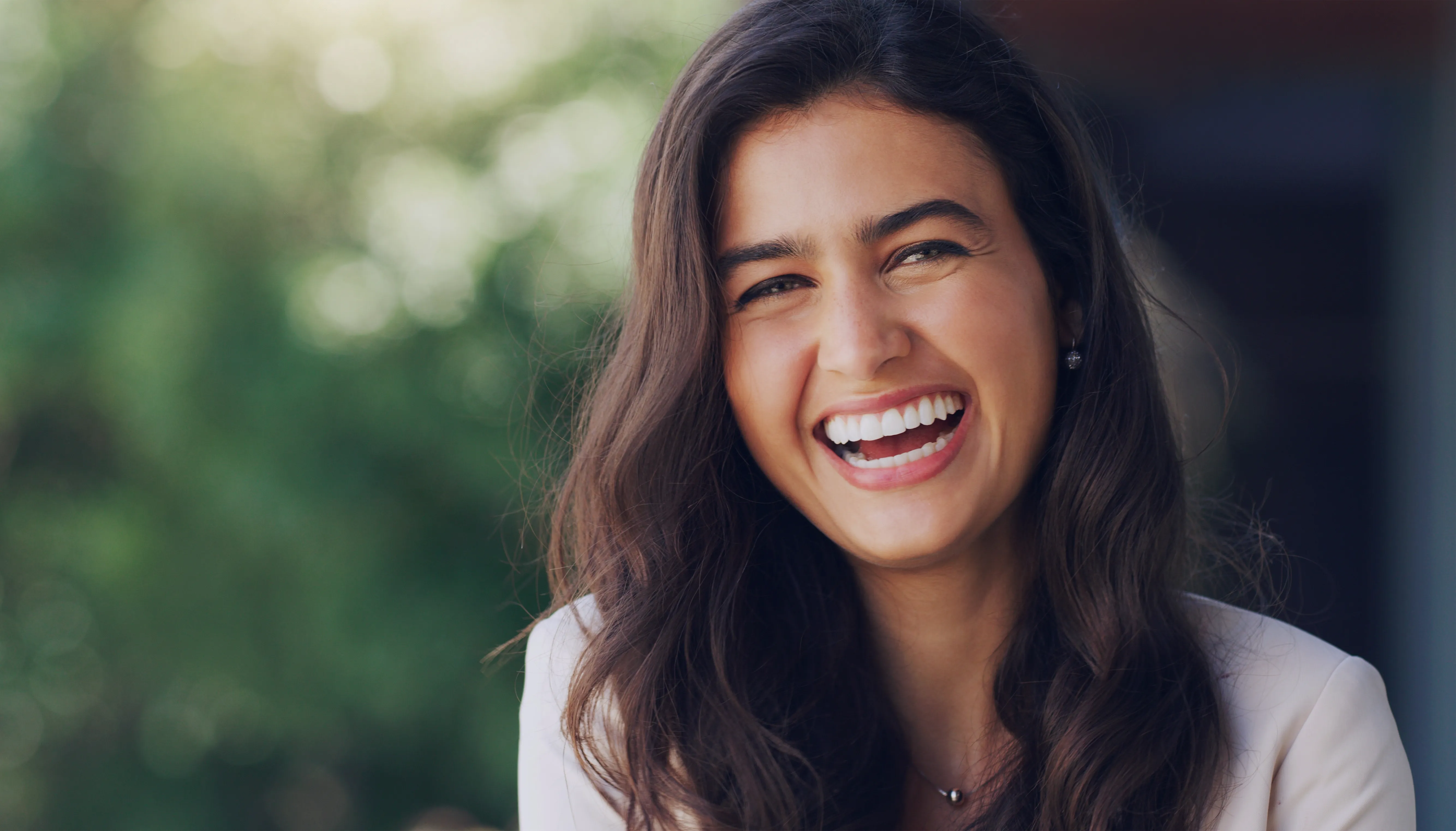A woman smiling outdoors