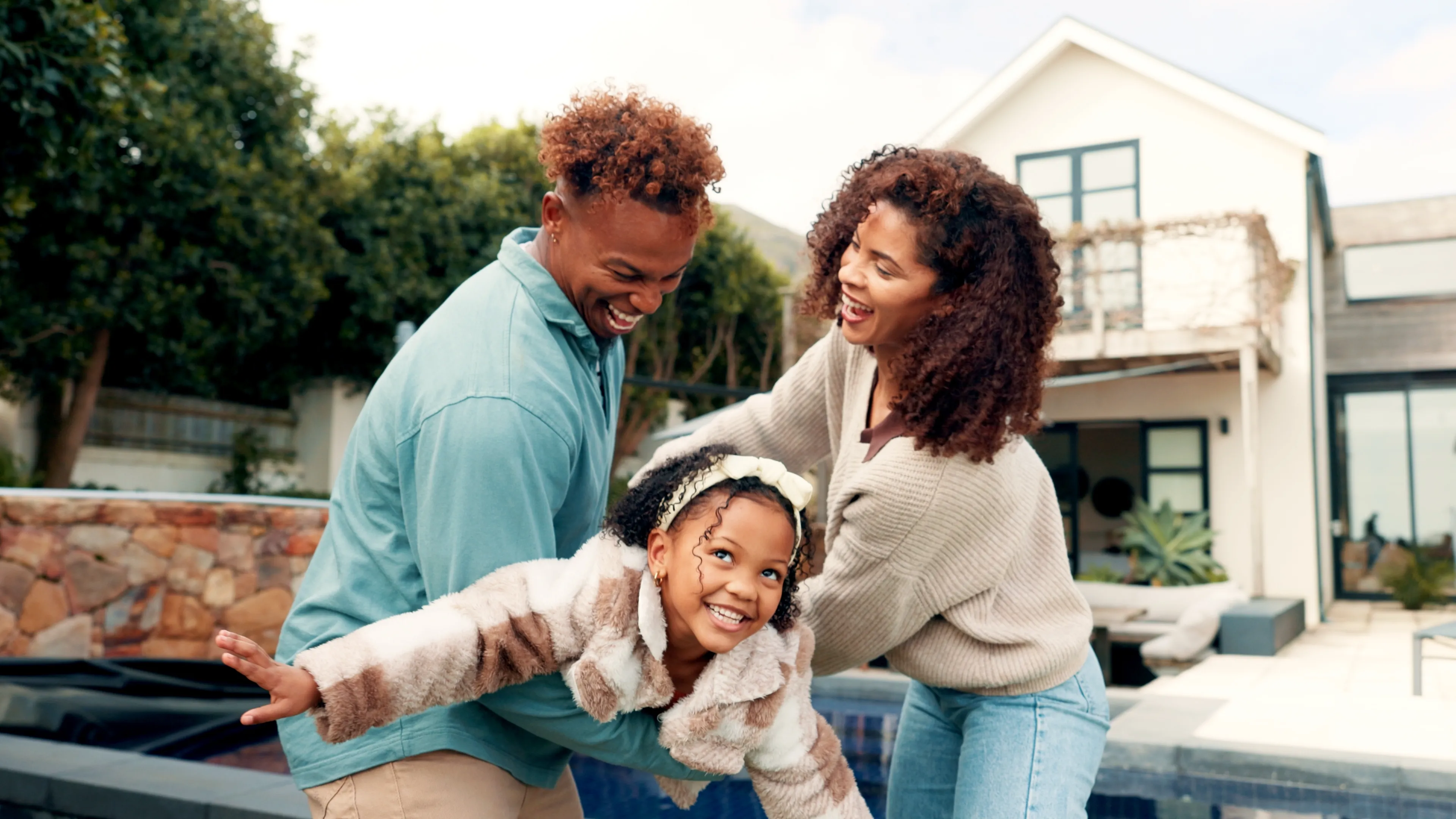 A family smiling together outdoors