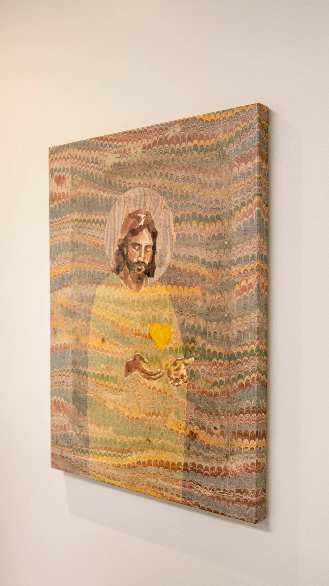 A faith-inspired painting hanging on an office wall